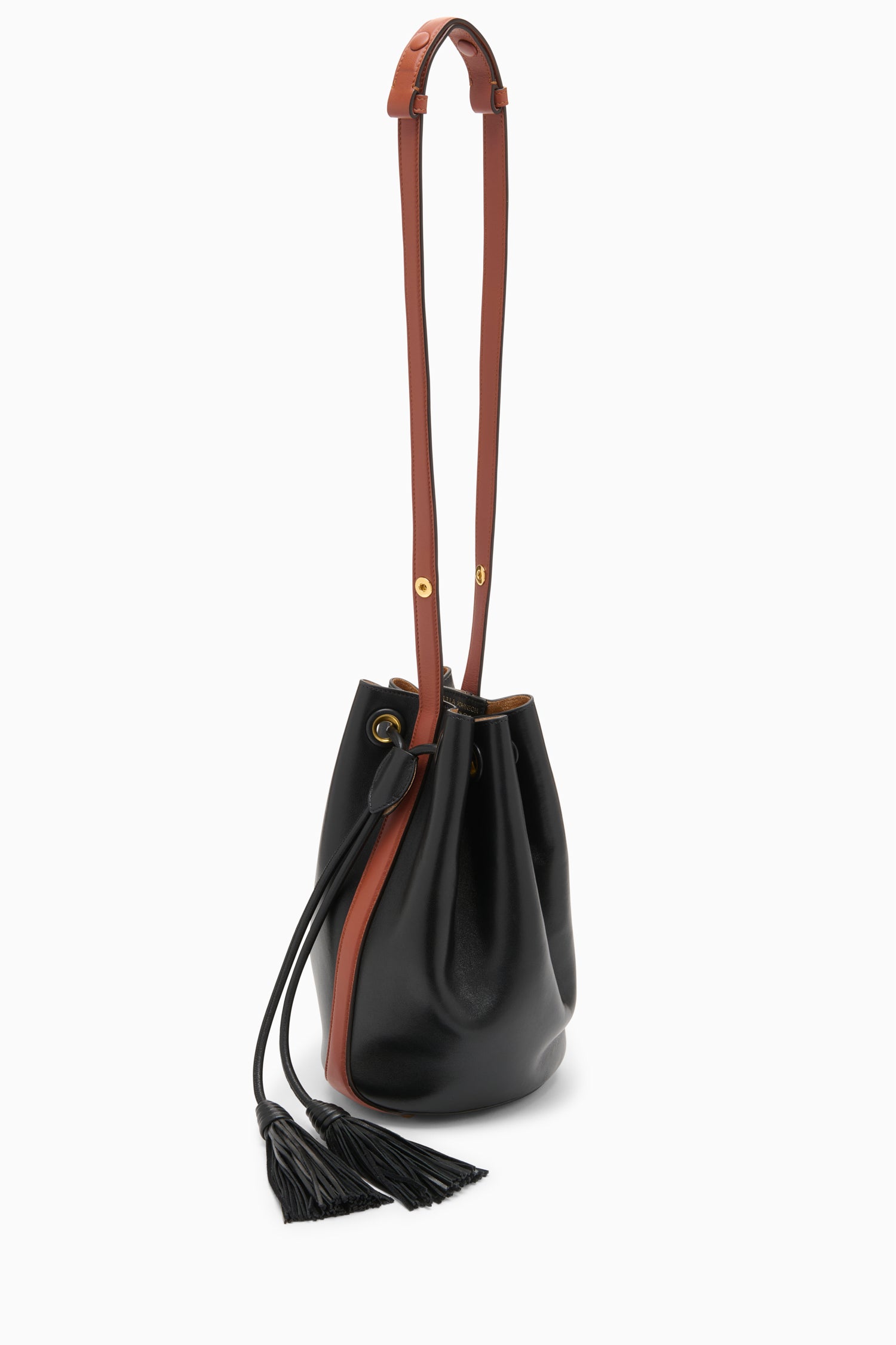 Ulla Johnson Black Nappa Leather Bucket Bag with Tan Strap and Tassels, Angled View | Ulla Johnson