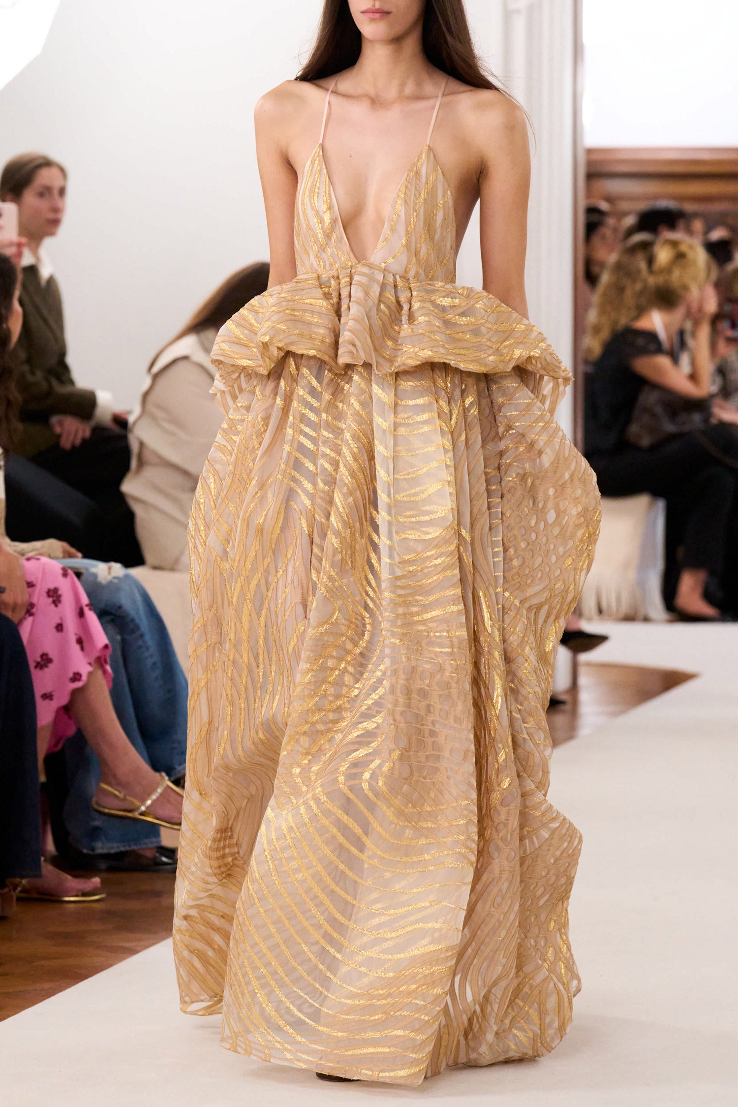 Ulla Johnson Woman wearing a gold evening gown at a formal event.