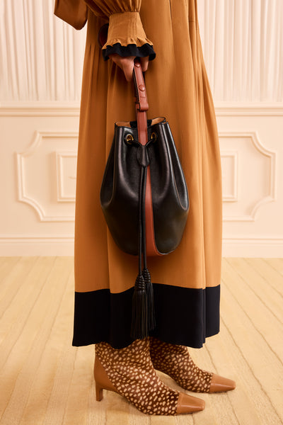 Black Leather Bucket Bag Handheld On Model, Drawstring Tassel Detail Close-Up | Ulla Johnson